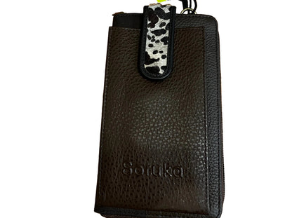 Brown leather wallet with a tag on a wooden surface