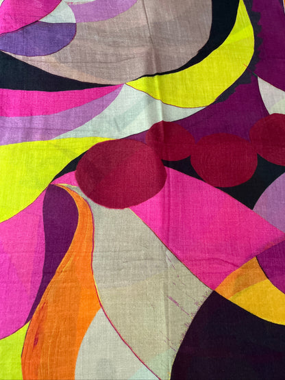 A close-up of a colorful abstract  60s inspired patterned scarf, , featuring bold organic shapes in pink, purple, yellow, orange, black, and beige.