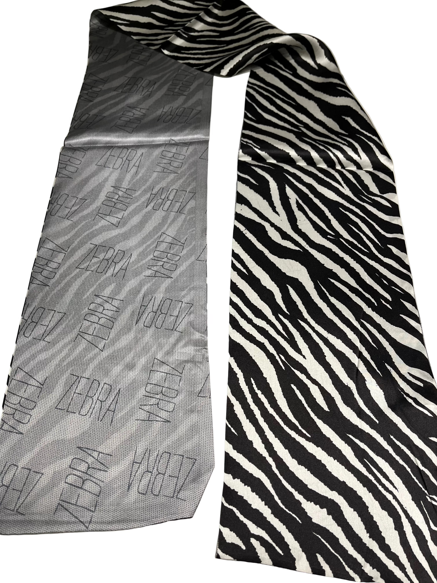 Two TONE scarf one gray with zebra pattern and the other black and white zebra pattern, on a light background.