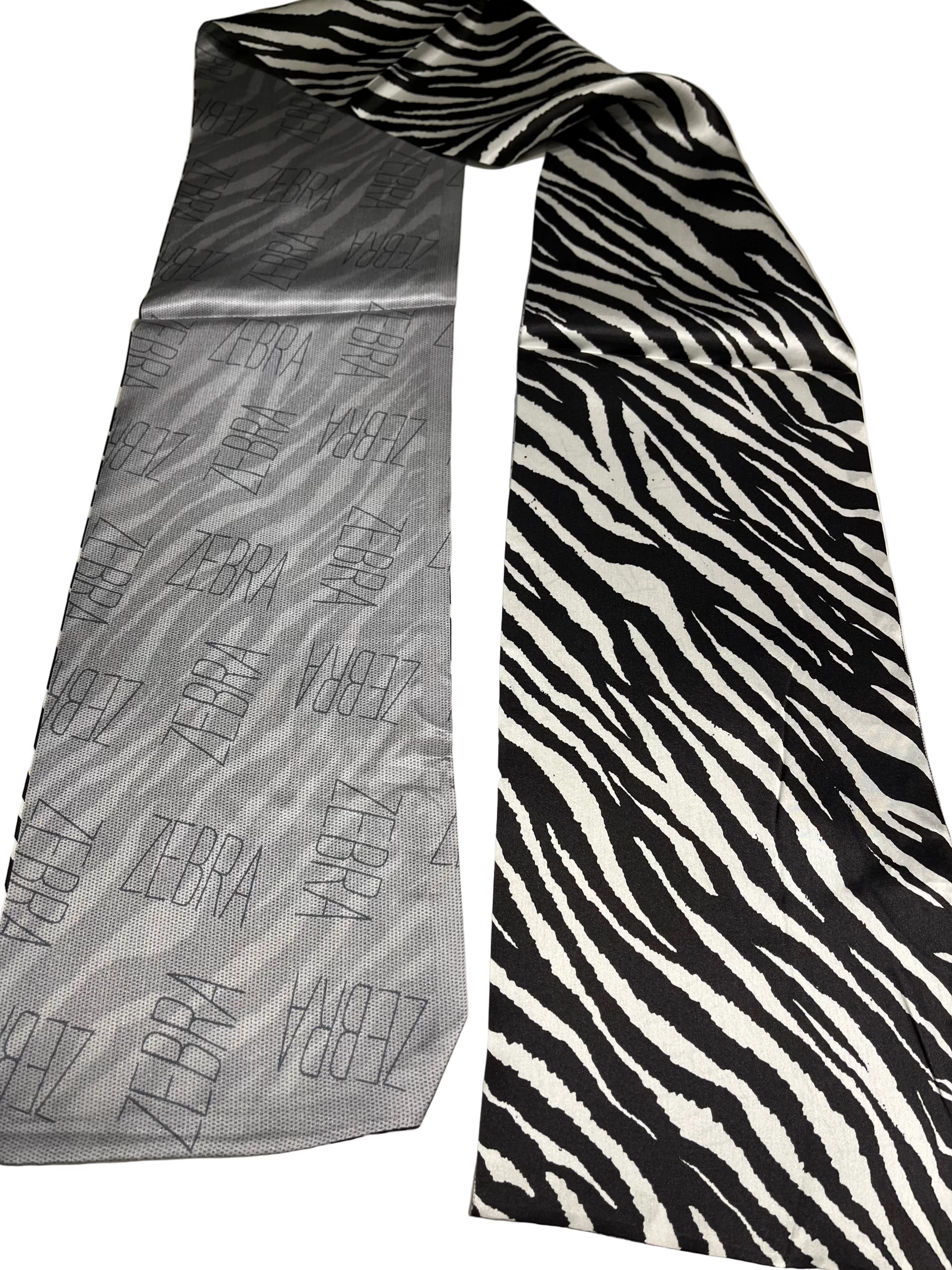Two TONE scarf one gray with zebra pattern and the other black and white zebra pattern, on a light background.