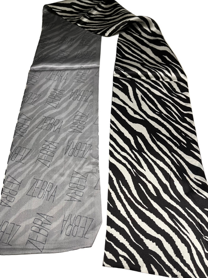 Two TONE scarf one gray with zebra pattern and the other black and white zebra pattern, on a light background.