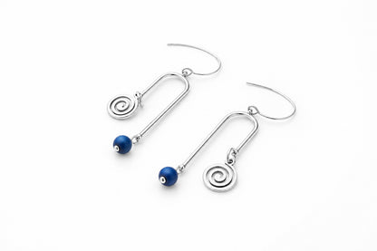 A pair of gold drop earrings with spiral charms and small dark blue beads, displayed on a clean white surface.
