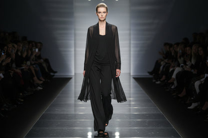 black  mini mesh cardigan on a model walking the catwalk