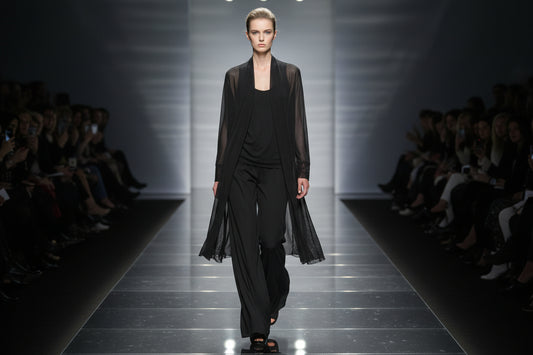 black  mini mesh cardigan on a model walking the catwalk