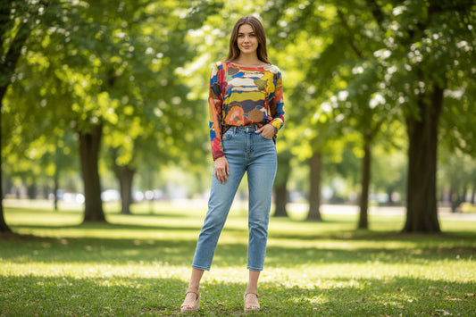Colorful patterned long-sleeve shirt on a model wearing cropped jeans in a park