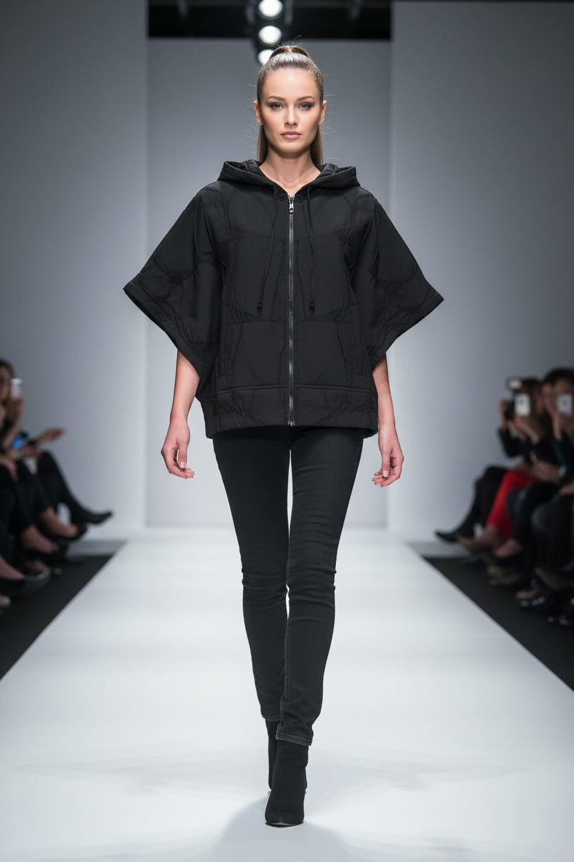 Black light quilted jacket with a hood and half sleeve on a white background