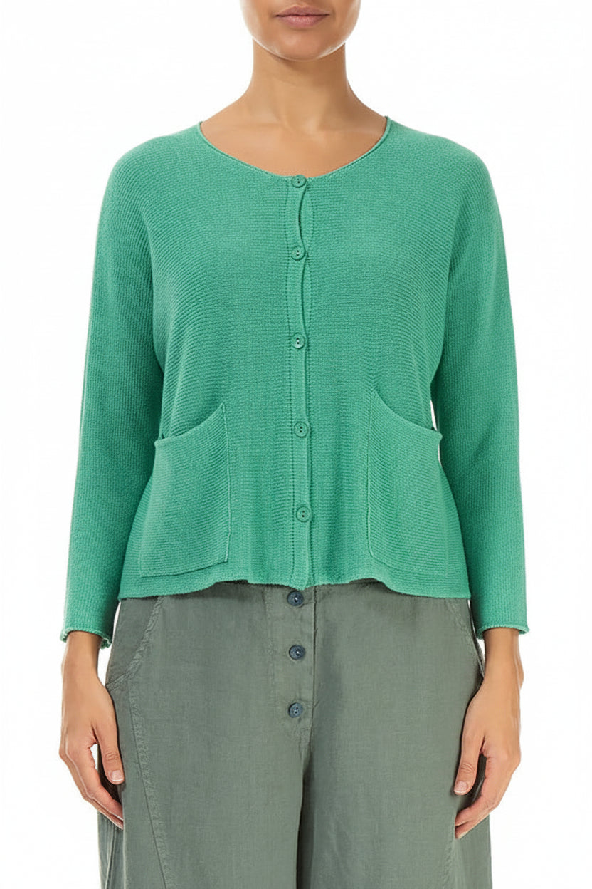 Green textured cardigan worn by a person on a white background