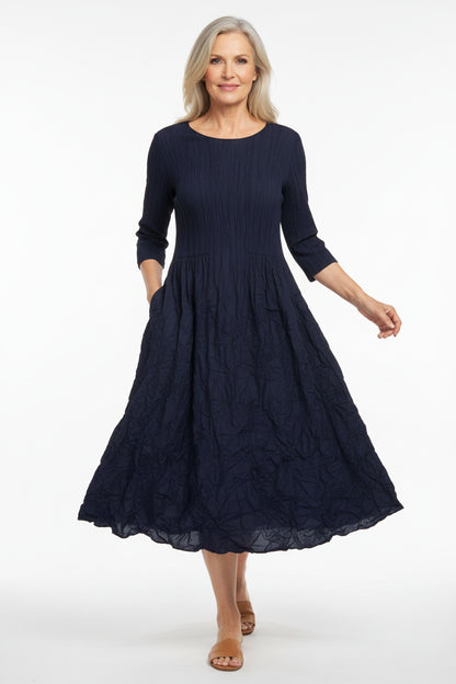 Textured navy blue dress with round neck and 3/4 sleeves on a white background