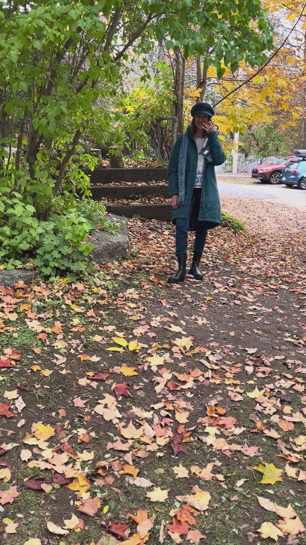 Cari wearing the Seasalt Plant Hunter raincoat in teal over a Habitat Alpine sweater and FDJ jeans, with a Mucros mohair scarf