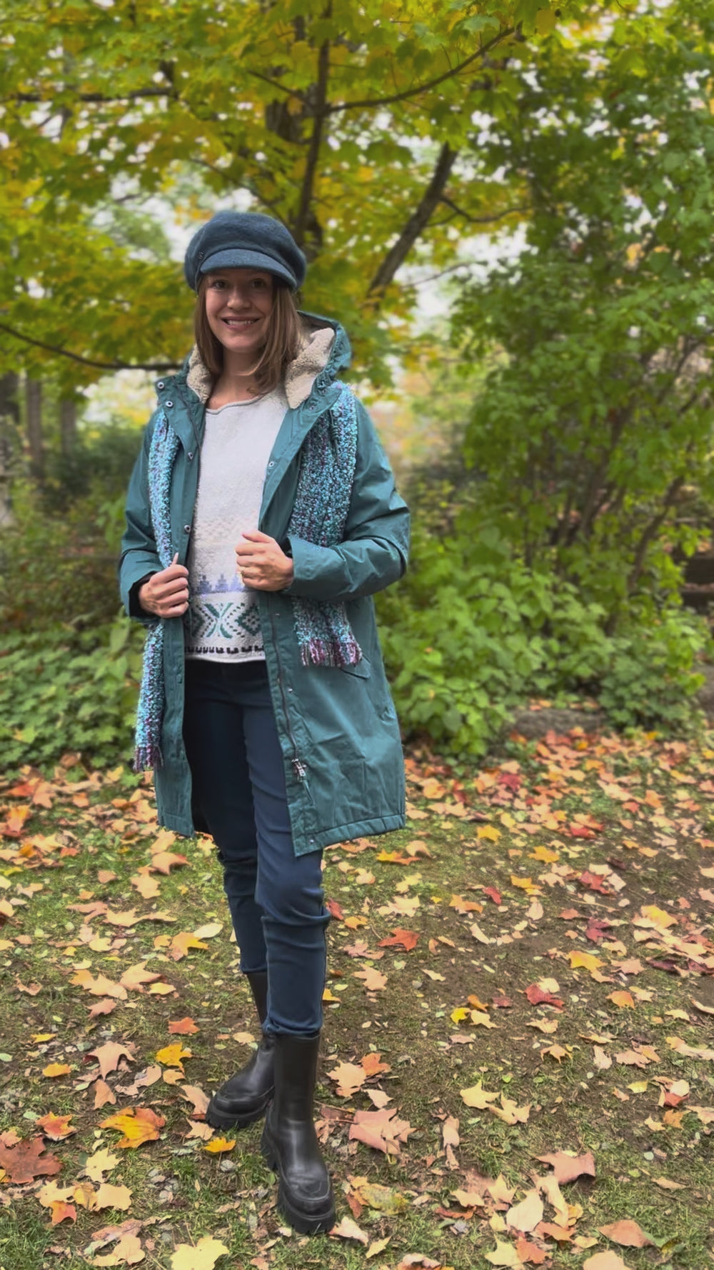 Cari wearing the Seasalt Plant Hunter raincoat in teal over a Habitat Alpine sweater and FDJ jeans, with a Mucros mohair scarf