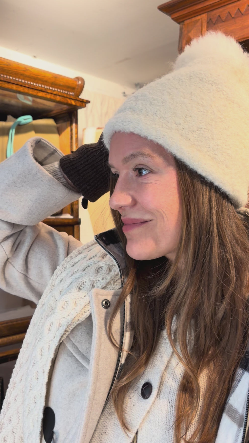Cari wearing the Junge Sophie Duffel Coat over the Cassia cardigan and White Stuff Millie Cord Shift Dress, with teal tights, an alpaca pompom hat and the Mucros Fiona bag