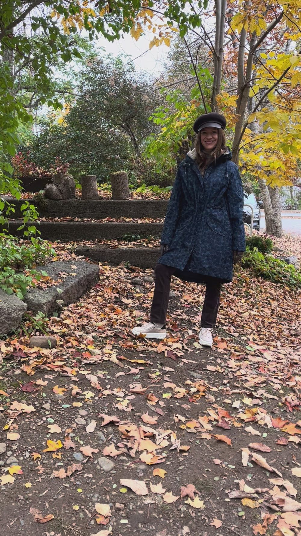 Cari wearing the Seasalt Plant Hunter raincoat in Squall print, B. Copenhagen turtleneck and Carreli chocolate cords, with a Loevenich cap and Auclair Sofia gloves