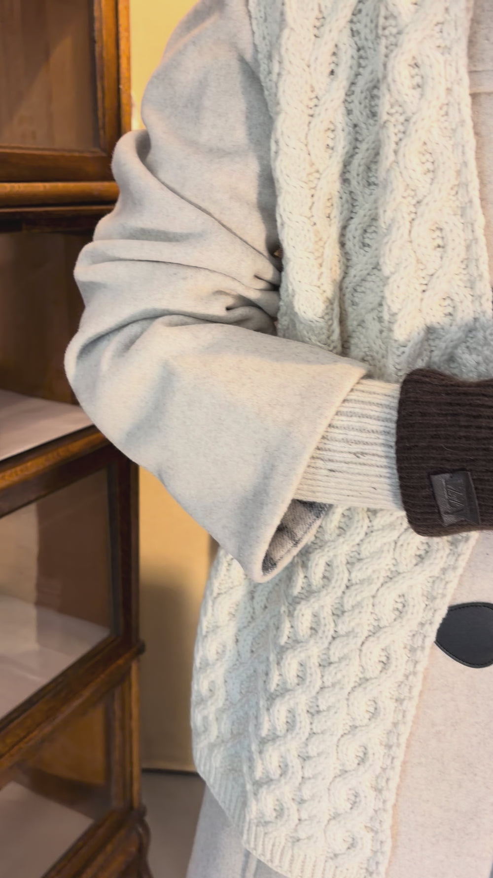 Cari wearing the Junge Sophie Duffel Coat over the Cassia cardigan and White Stuff Millie Cord Shift Dress, with teal tights, an alpaca pompom hat and the Mucros Fiona bag